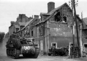 An M7 dives through the French town of Carentan in June 1944, not long after the Allies landed in Normandy. (National Archives)