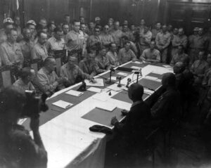 Seated at the right side of the end of the table is Colonel Volckmann, the lowest-ranking Allied delegate at the conference table during the surrender of Japanese forces in the Philippines, 3 September 1945. From left of table to right is Lt. Gen. Jonathan Wainwright, LT. Gen. Wilhelm Styer, Maj. Gen. Edmond S. Leavey, Lt. Gen. Arthur Percival (British Army), Maj. Gen. Walter Wood, Maj. Gen. Robert Beightler, Commodore Norman Gillette, Brig. Gen. Robert McBride, and Col. Russell Volckmann. (National Archives)