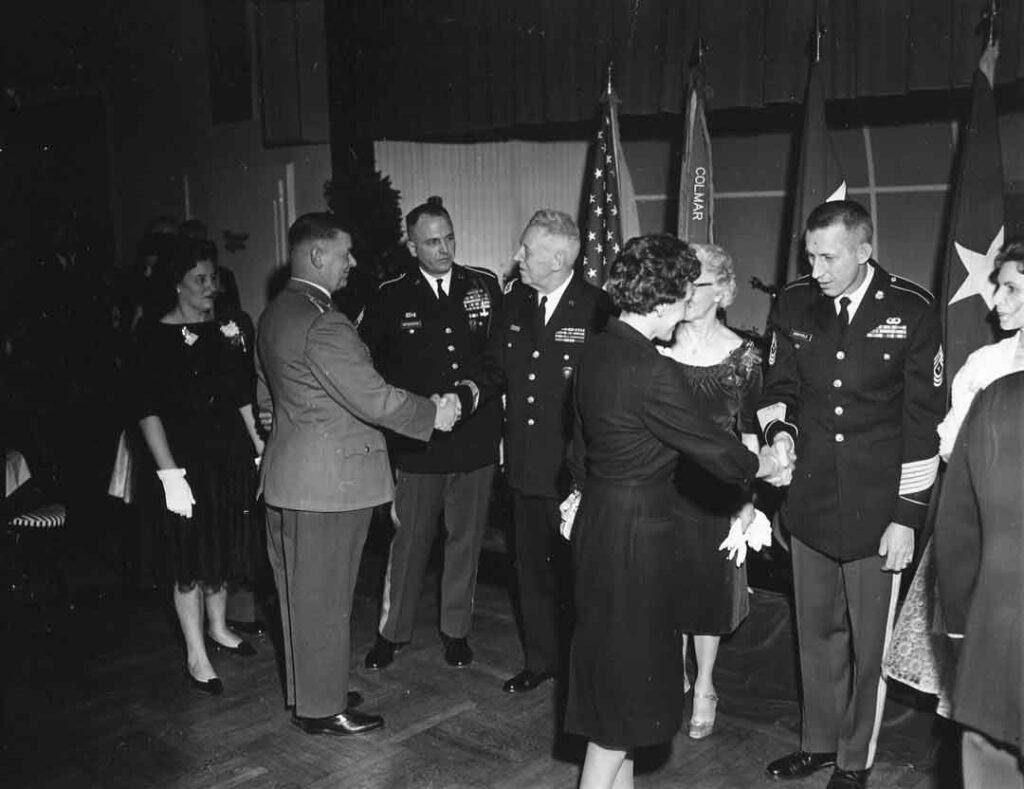 General Clarke (third from left), outgoing commanding general of USAREUR, shakes hands at a reception at Leighton Barracks, Würzburg, West Germany, 5 March 1962. His mandatory retirement for age, delayed by a year, came less than two months later. (National Archives)