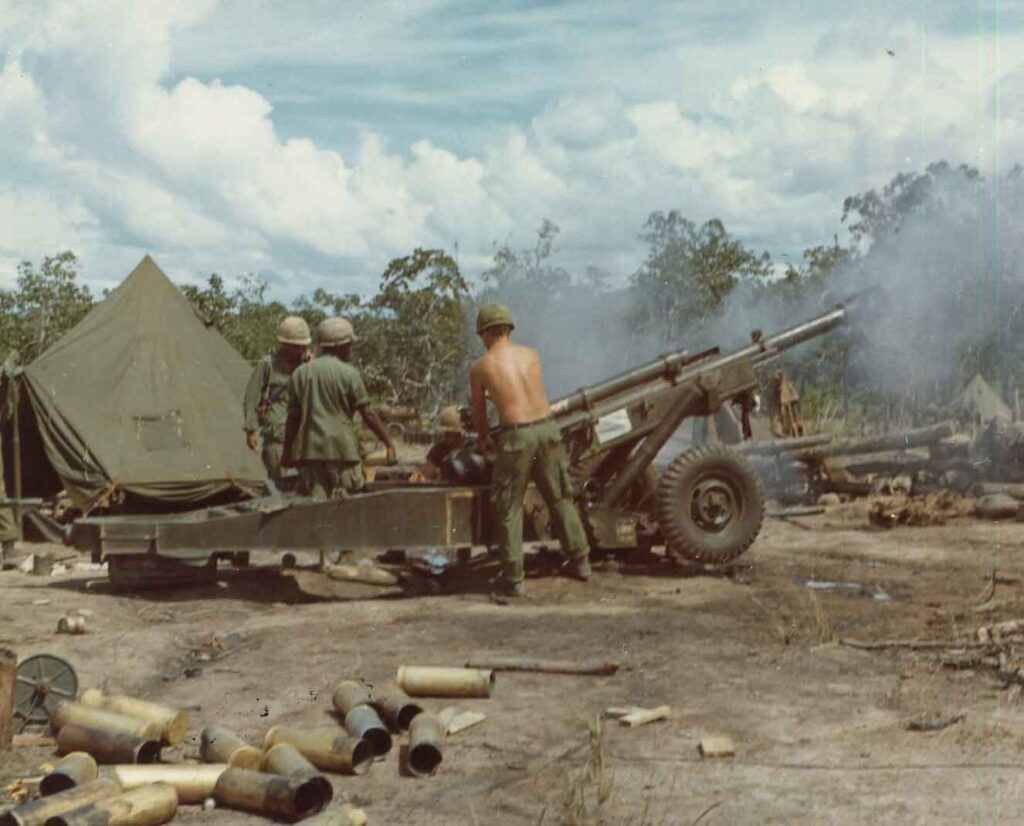 A gun crew from Battery B, 1st Battalion, 77th Artillery, 1st Cavalry Division (Airmobile), fires an M102 from Landing Zone (LZ) Fatima, Republic of Vietnam, 26 August 1966. (National Archives)