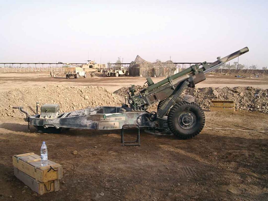 This photograph shows an M102 belonging to Battery A, 1st Battalion, 206th Field Artillery, 39th Infantry Brigade Combat Team, at Fire Base Paris, Camp Taji, Iraq, during Operation IRAQI FREEDOM II, 29 May 2004. (Damon Neil Clouck) 