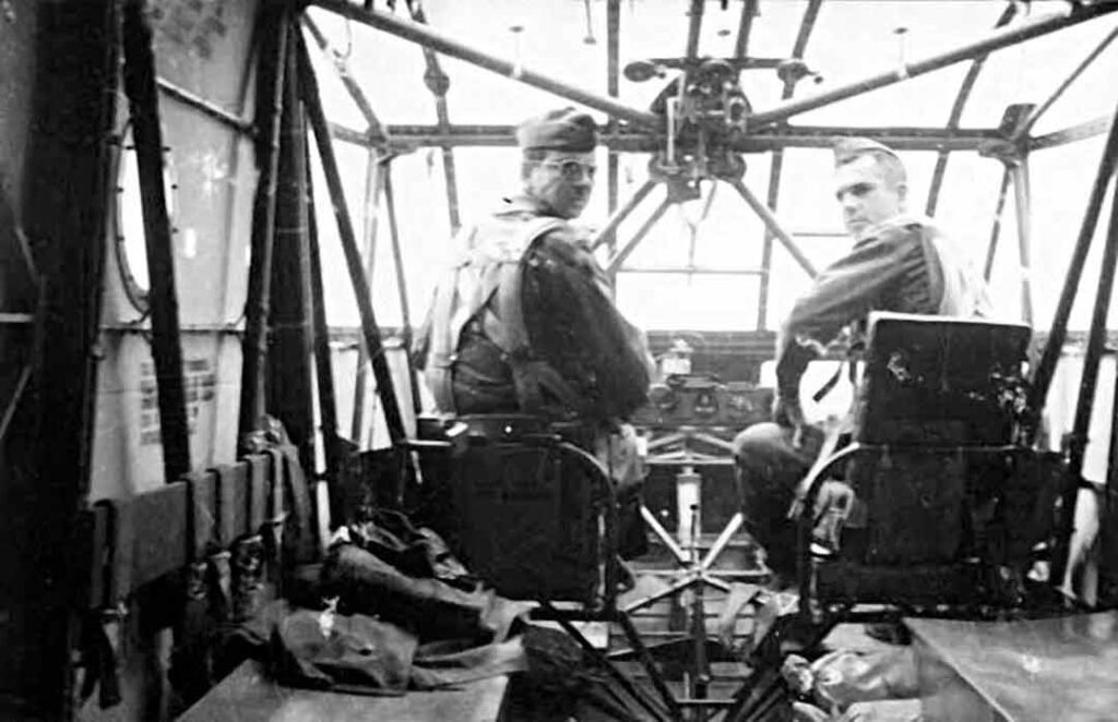 The pilot and co-pilot of a CG-4A sit in the cockpit compartment of their glider. (U.S. Army Special Operations Command History Office)