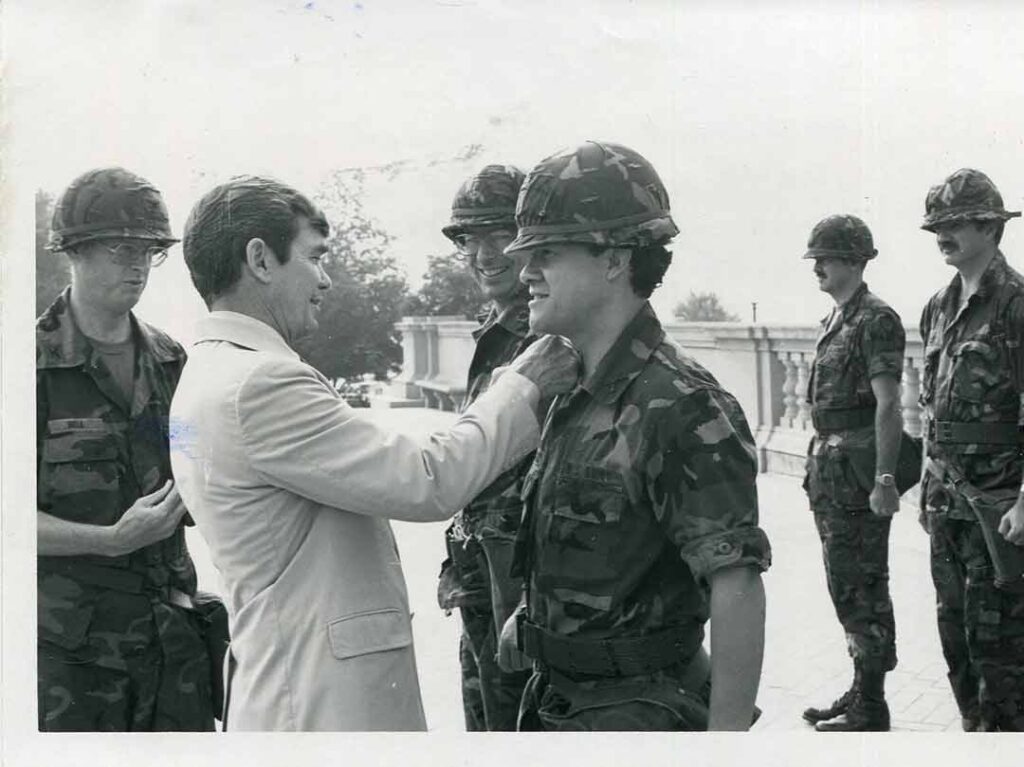 Ambassador Bruce Laingen, Vice-President of the National Defense University, promotes Captain Felix Vargas to the rank of major during GLOBEX ’83 in June 1983. Vargas, a State Department employee soon on his way to a posting in El Salvador, was one of several experienced federal workers assigned to the 5th PSYOP Group. 